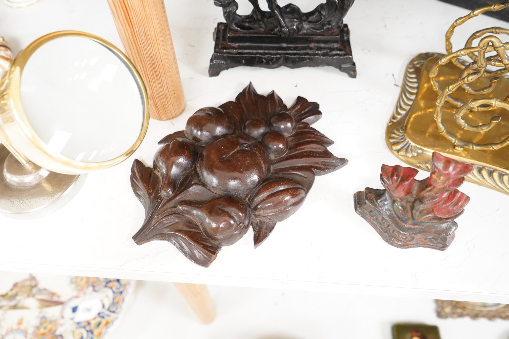 Sundry items to include an iron money box, brass letter rack, horse door stop and a 19th century oak carving, largest 32cm high